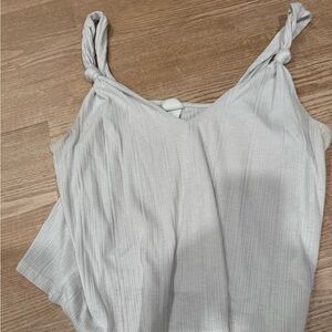 White tank top with cute shoulder detail. Lightly worn